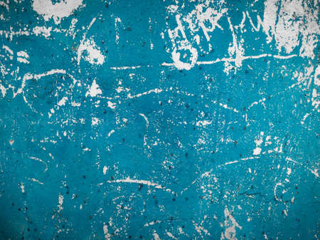 The texture of the scratched wall in blue. Old rough painted surface. Aged blue wall with white scratches. Design element of abstract construction background. Foreground.の写真素材