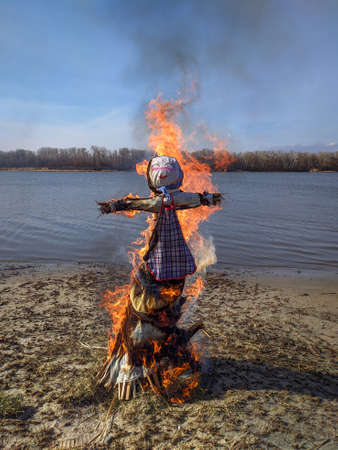 Azov, Russia - March 14, 2021: Burning effigy on the last day of Shrovetide. Russian Maslenitsa festival or Pancake weekのeditorial素材