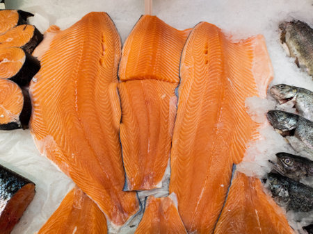 Fillet of red fish in ice on the counter. Open showcase with seafood.の写真素材