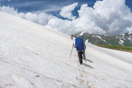 Sports people tourists walk along the beautiful mountains in the snow.の写真素材