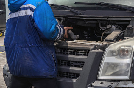 Mechanic fixing the engine of a vanの写真素材