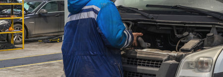 Mechanic fixing the engine of a vanの写真素材