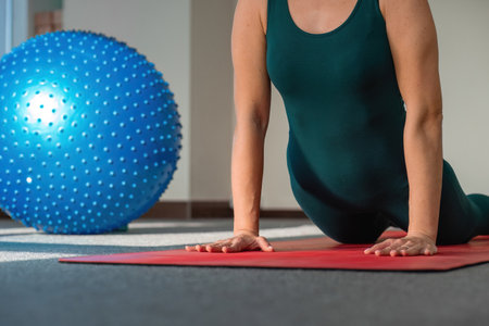 Stretching, yoga and woman on the red carpet for training, exercise. Legs, stretching and lady with flexible fitness or pilates workouts for balance, meditation or wellness.の写真素材