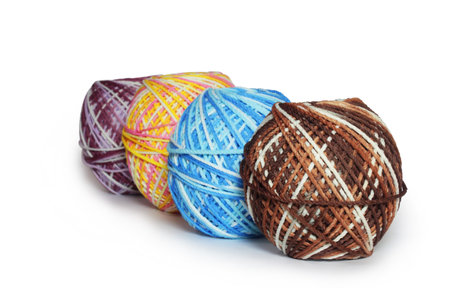 Ball of yarn in mixed colors of white, pink, yellow, blue, brown, purple. Can be used for knitting or crochet. Isolated on white backgroundの写真素材