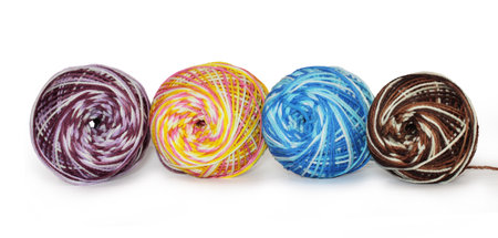 Ball of yarn in mixed colors of white, pink, yellow, blue, brown, purple. Can be used for knitting or crochet. Isolated on white backgroundの写真素材