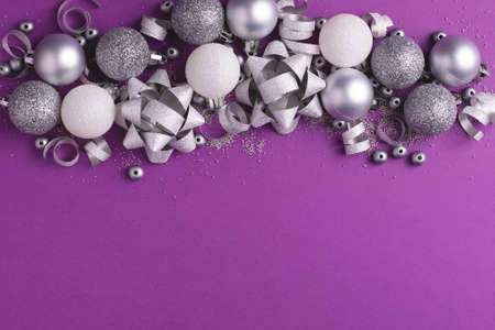 New Year party background. Christmas metallic decorations on purple. Copy space.の写真素材