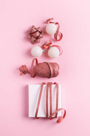 Festive Christmas decorations arranged on pink background. Flat lay. Christmas and New Year concept.の写真素材