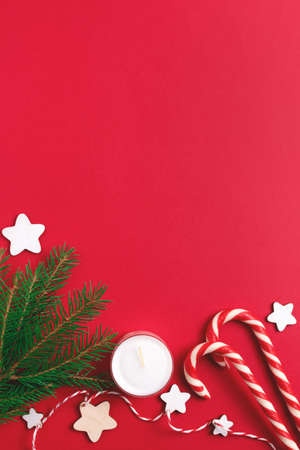 Christmas background with season decoration on red. Top view, copy space.