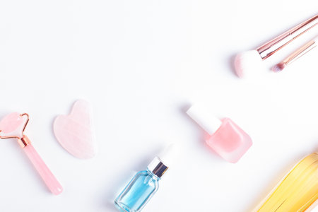 Beauty and self care flat lay with copy space. Face care, nail care and makeup accessories arranged on white background, top view.の写真素材