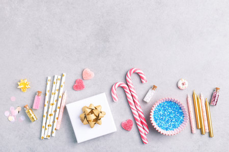 Happy birthday composition with gifts, holiday decorations and sweets on grey background, top view. Birthday party, celebration flat lay with copy space.の写真素材