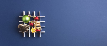 New Year creative banner with Christmas decorations on dark blue background. Top view, copy space.