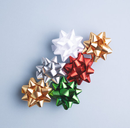 Ð¡olorful gift wrapping bows on gray-blue background. Festive decorative ribbon set for present packaging, top view.の写真素材