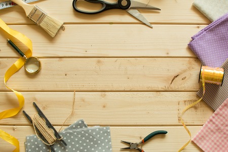 Sewing materials on wooden board. Background for your craft projects.の写真素材