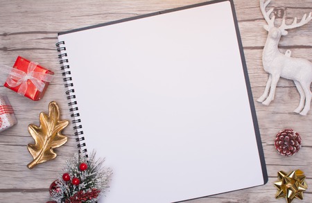 Christmas letter writing on white paper on wooden background with decorations.の写真素材