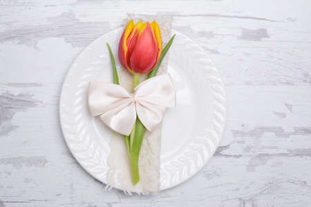 Easter eggs and tulips over wooden background.の写真素材