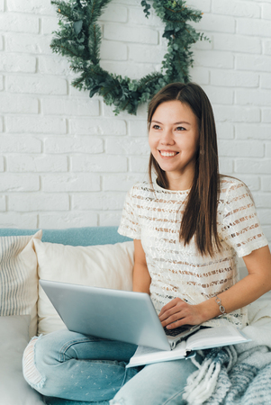 Cute girl with laptop sitting smiling. Happy girlの写真素材