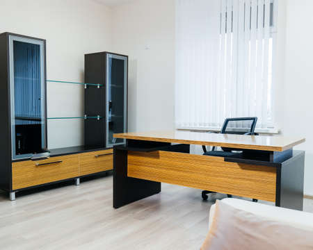 office room interior with desk and armchair. A sample of office furniture in a furniture showroom.