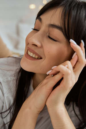 Portrait of a smiling young beautiful woman. Girl with closed eyes.の写真素材