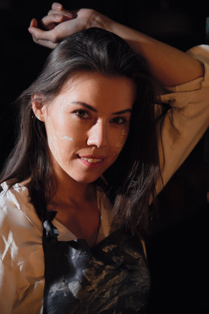 Portrait of a beautiful girl in a pottery workshop.の写真素材