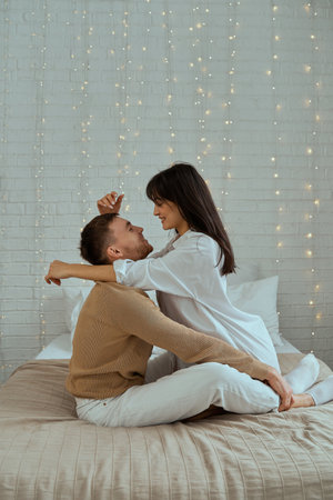 The girl and the guy are hugging on the bed. The concept of love, relationships.の写真素材