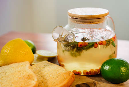 Beautiful glass teapot with sea buckthorn tea. Hot winter drinksの写真素材
