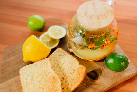 Beautiful glass teapot with sea buckthorn tea. Hot winter drinksの写真素材