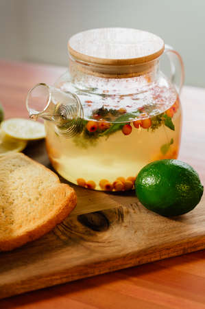 Beautiful glass teapot with sea buckthorn tea. Hot winter drinksの写真素材