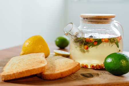Beautiful glass teapot with sea buckthorn tea. Hot winter drinksの写真素材