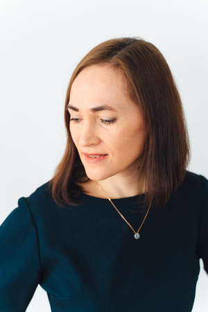 portrait of a beautiful attractive successful woman aged 40 in a blue dress.の写真素材