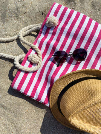 leisure and summer vacation concept - string bag, sunglasses, straw hat, bagの写真素材
