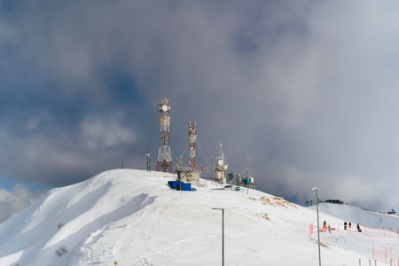 Antennas of communication equipment on top of a snowy mountain. Telecommunications tower high in the mountains. Rosa Khutor.の写真素材
