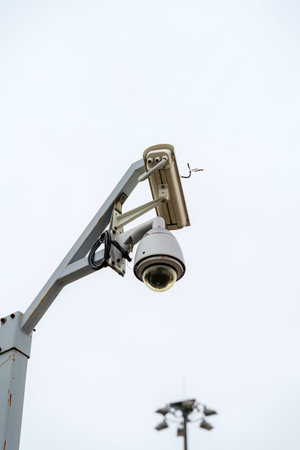 CCTV cameras mounted on a pole. Professional security cameras scan the street. Surveillance, privacy, crime, technology, espionage, equipment, protection and security concept.の写真素材