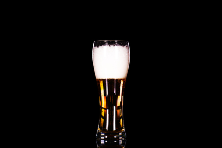 Beer glass with foam on black background.の写真素材