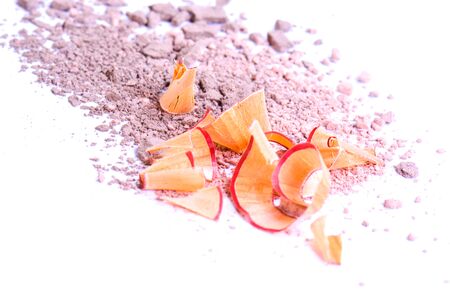 Cosmetic pencil shavings with powder on background.の写真素材