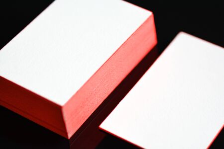 thick white cotton paper business card mock up with red painted edges. Blank business cards template.の写真素材