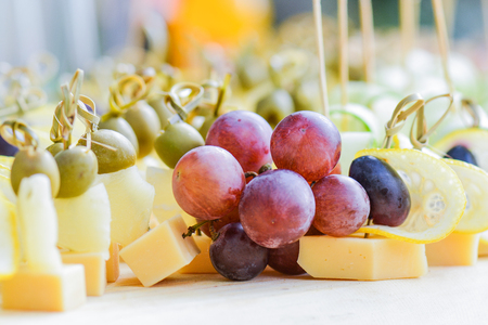 Beautifully decorated catering banquet table with different food snacks and appetizers on corporate christmas birthday party event or wedding celebrationの写真素材
