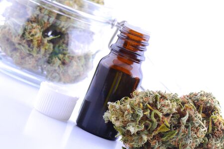 Medicinal marijuana cannabis with extract oil in a bottle. cannabis CBD oil hemp products. Cannabis oil extracts in jar.の写真素材