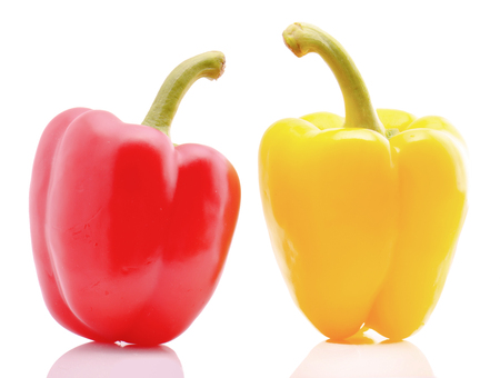 Red and yellow sweet peppers on white backgroundの写真素材