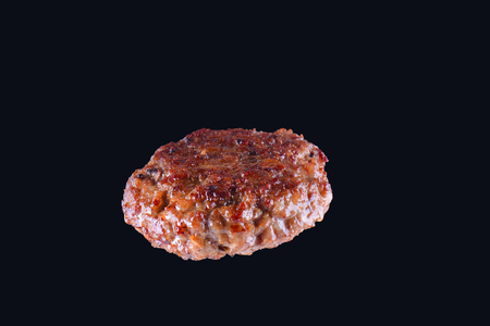 Fried fresh large beef burger isolated on white background. Grilled burger cutlet isolated on blackの写真素材