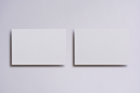 Photo of blank white business cards on white. Mock-up for branding identity. For graphic designers presentations and portfolios.の写真素材