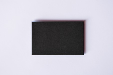 Mockup of blank textured black business card at white background.の写真素材
