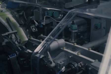 Drug Production. Medical vials on pharmaceutical manufacturing line. Medical ampoules on automated...