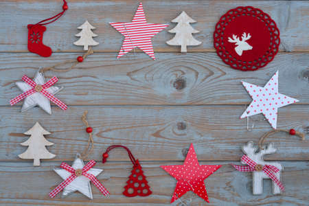 White red christmas decoration as Christmas tree, reindeer and star on a gray old wooden planks...