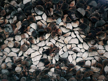 Split wood, cut and arranged ready for winter. Background wood texture.