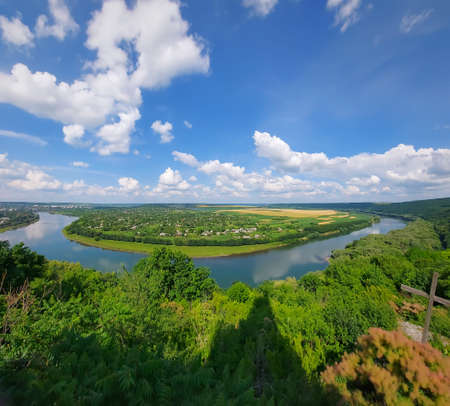 Panoramic view of the Dniester River in the Soroca region, Republic of Moldova. Blue sky with white...