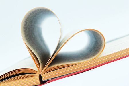 Book open on the table with heart shaped pages の写真素材