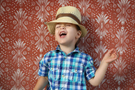 Portrait of young boy against vintage wallの写真素材