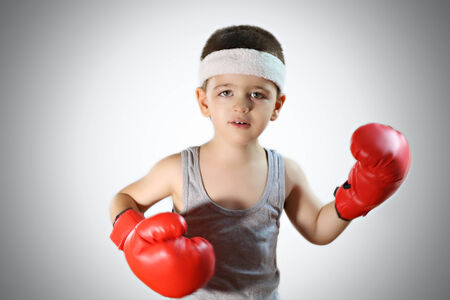 Super cute young boy with boxer glovesの写真素材