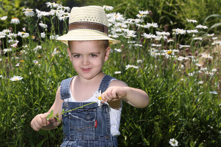 Cute child in the garden during the summer dayの写真素材