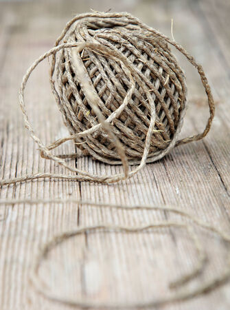 Roll of twine on the wooden table. Shallow depth of field.の写真素材